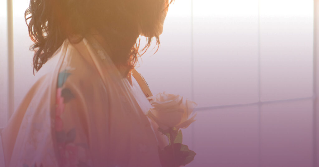 Photo of woman holding a flower